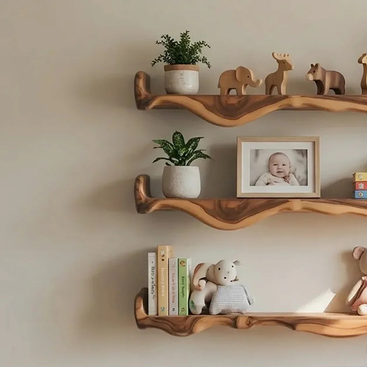 natural wood floating shelves in nursery with baby books, toys, and soft decor items