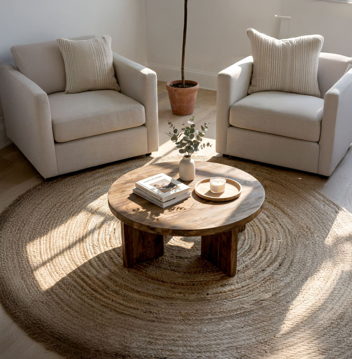 Japandi solid wood round coffee table styled in a minimalist living room