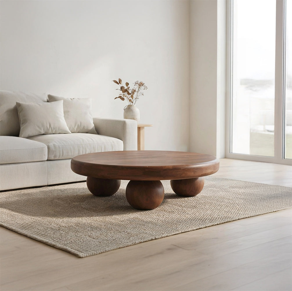Modern sculptural coffee table with spherical legs displayed in a contemporary living room