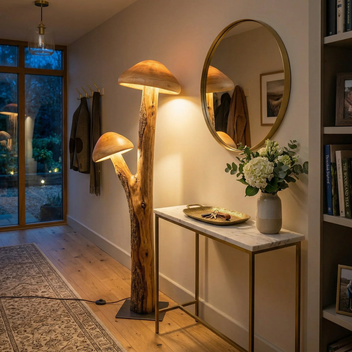 Sculptural mushroom floor lamp with natural wood base and dual glowing caps in a cozy hallway