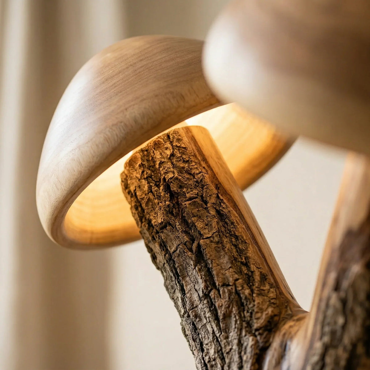 Close-up of mushroom-shaped floor lamp with glowing wooden caps and natural bark trunk