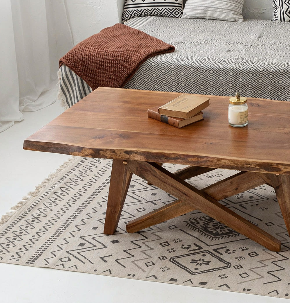 Organic modern coffee table featuring natural live edge details and a rustic X-shaped base