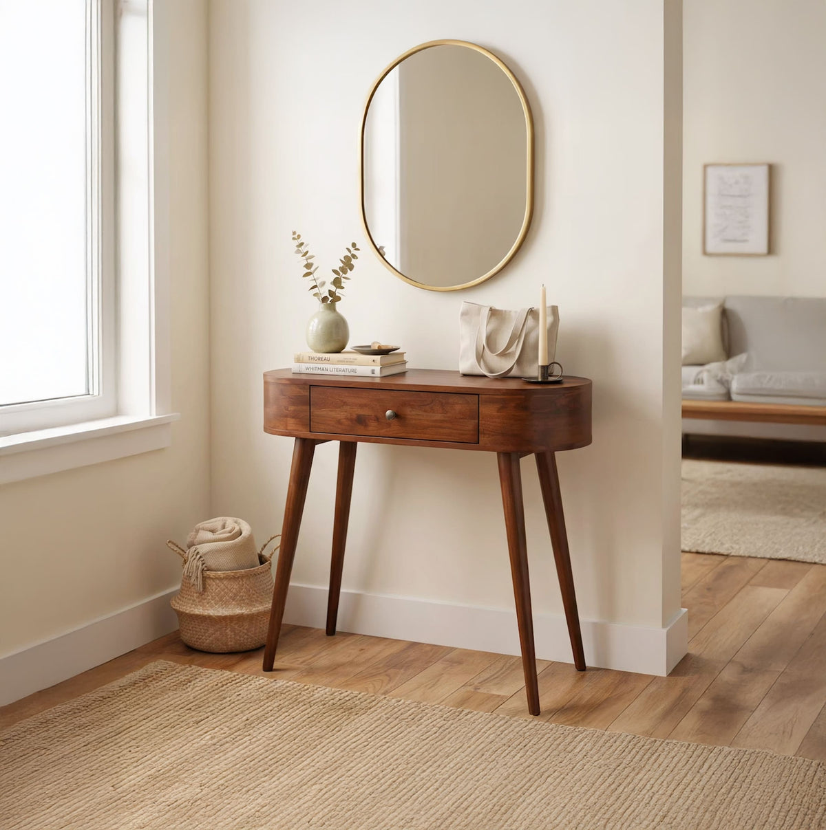 Curved solid wood entryway table with drawer styled in a Japandi-inspired foyer