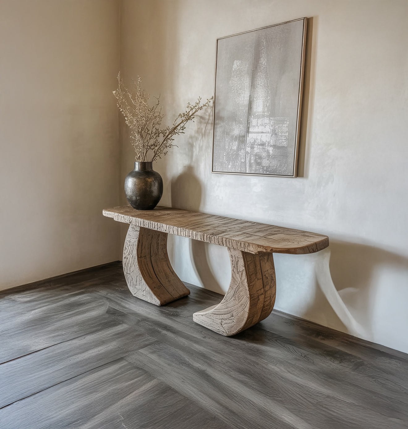 Minimalist interior with carved wooden bench, dark vase with dried branches, and abstract wall art