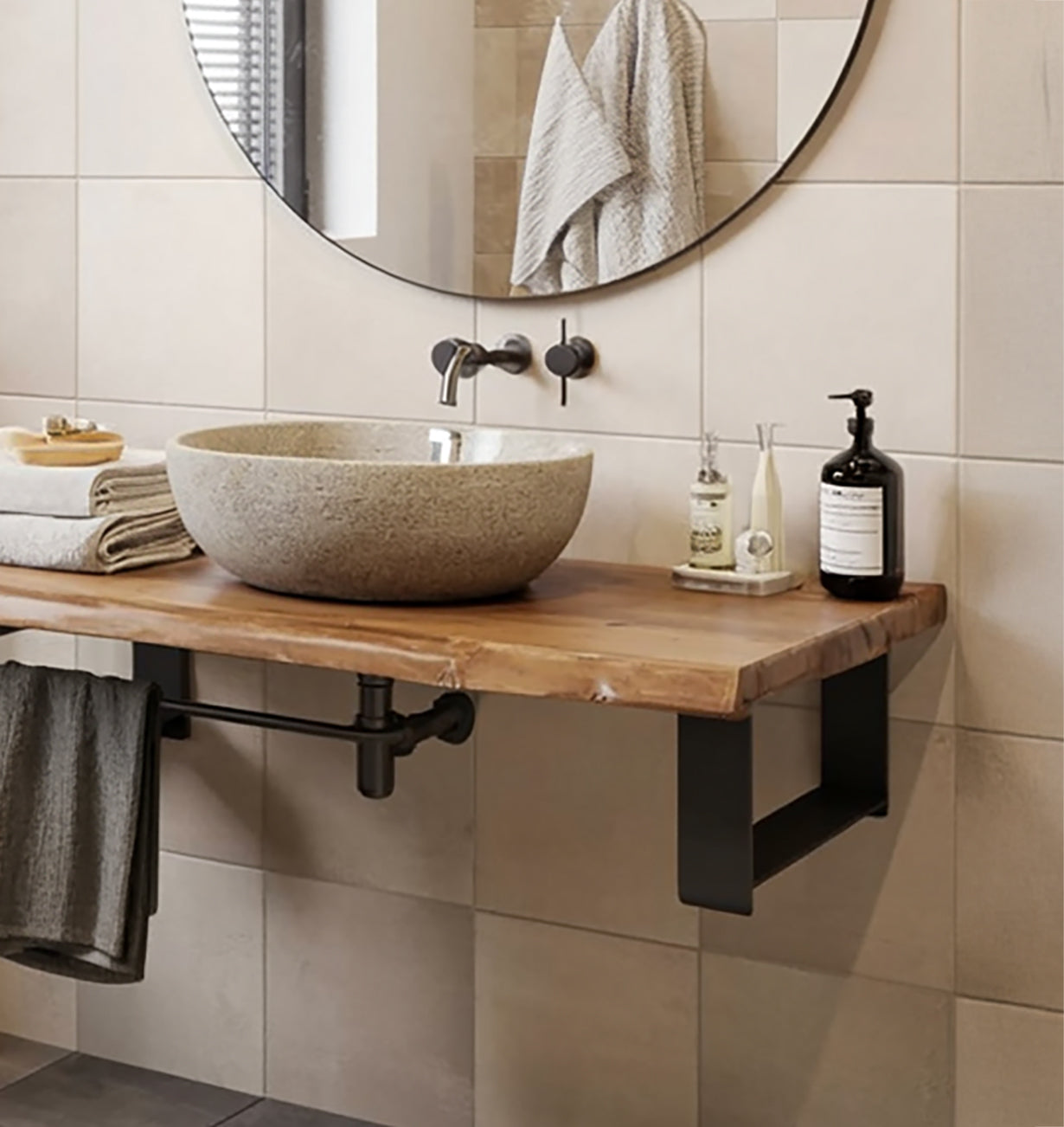 Modern bathroom with stone vessel sink on wooden countertop, round mirror, and wall-mounted faucet
